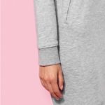 Zoom sur la main d'une femme portant une robe grise